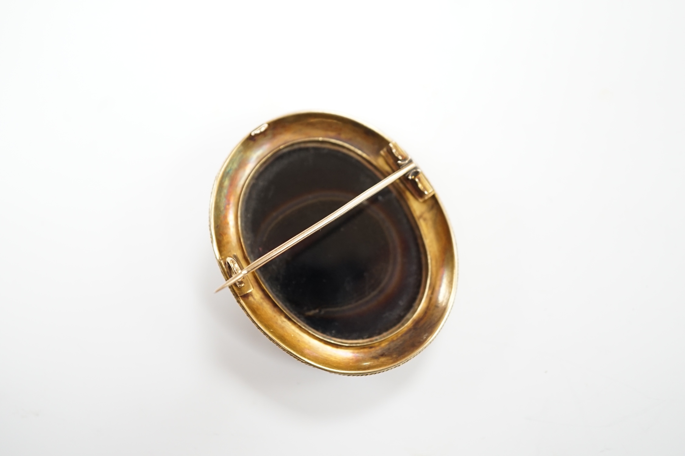 A Victorian yellow metal mounted cameo agate oval brooch, carved with head of a classical goddess to dexter, with beaded border, 49mm